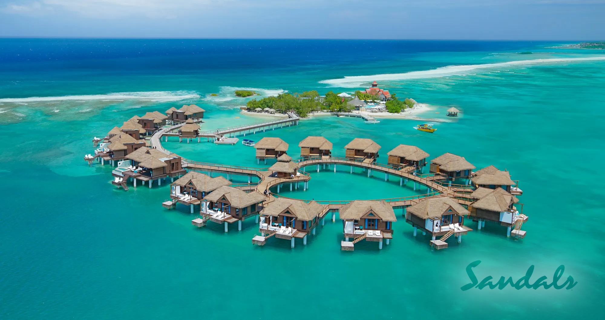 Serene overwater bungalows nestled in a picturesque setting of turquoise waters and blue skies, offering a peaceful retreat for relaxation_